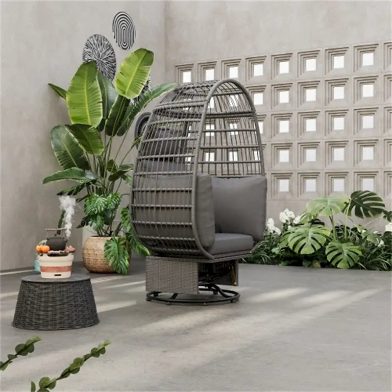 Fauteuil pivotant de jardin en rotin en forme d'œuf avec coussins et fonction à bascule